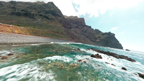 fpv drone over rocky la palma coast with turquoise sea views