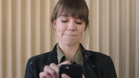 portrait-of-cute-young-pensive-woman-texting-browsing-using-smartphone-mobile-technology-smiling-enjoying-social-media-communication