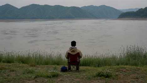 man contemplating the river view