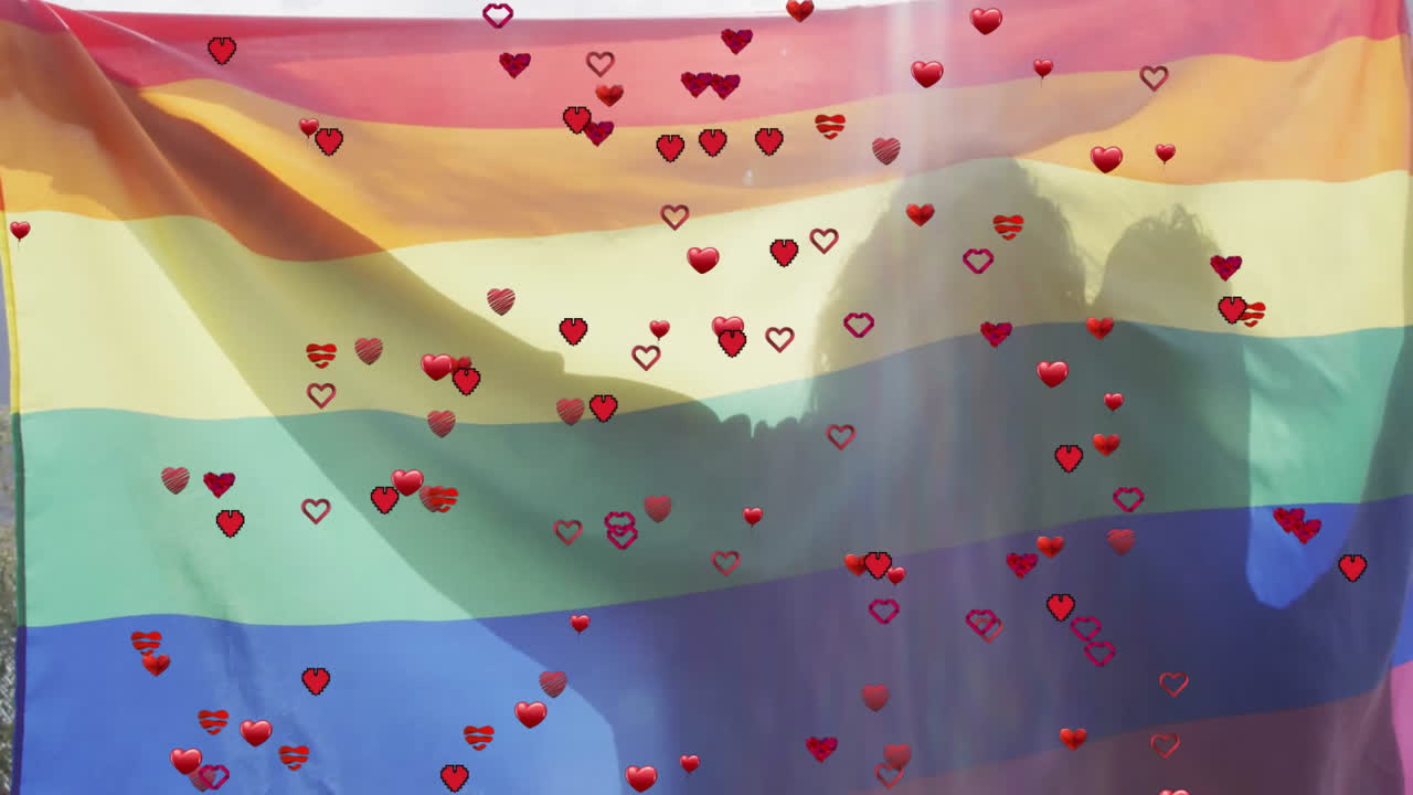 couple embracing behind Pride flag in outdoor business presentation, with floating heart graphics