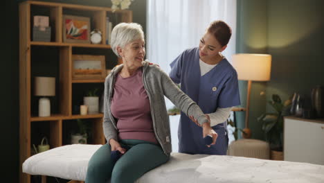 senior woman receiving physical therapy at home
