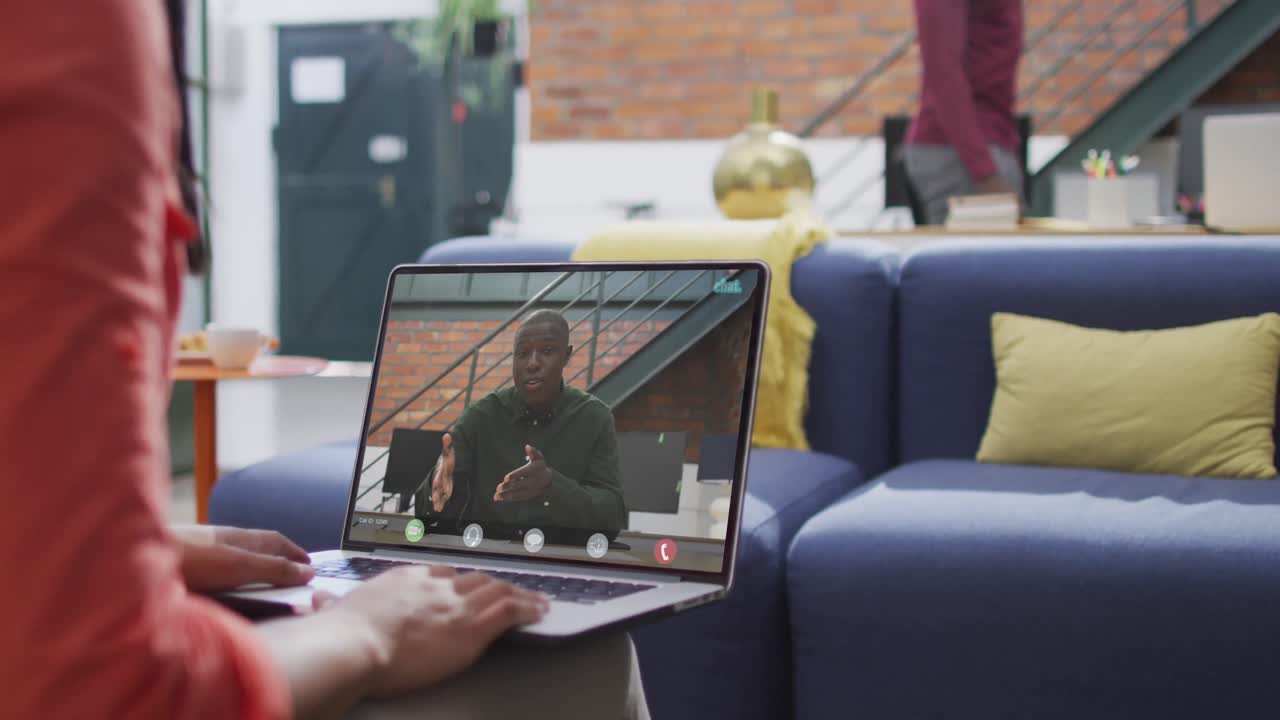 Biracial businesswoman using laptop for video call with african american business colleague