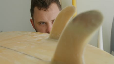 male surfboard maker in his workshop