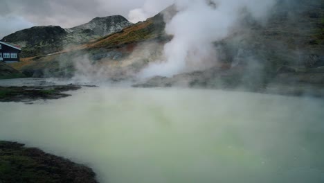 reveal shot of house by a hot spring