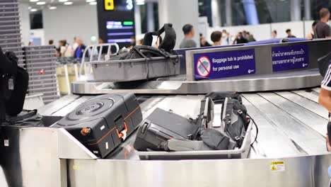 airport baggage carousel with travelers