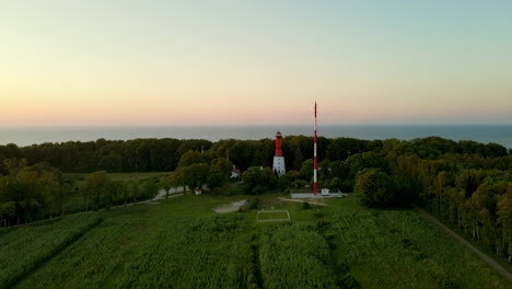 19th-century lighthouse in rozewie seaside village near plaza rozewie beach and views of the baltic sea on colorful sunset, aerial