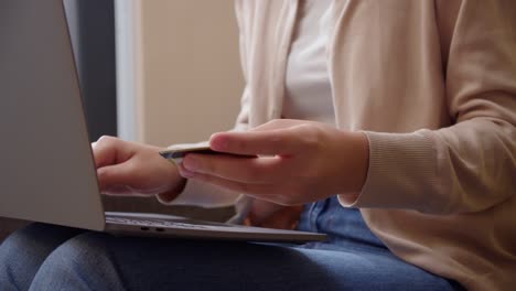 close up woman holding smartphone and banking mockup credit card for online shopping at home.female purchasing goods or services online store.transaction or payment online.modern concept.