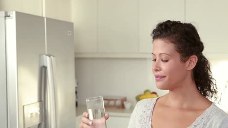 pregnant woman drinking glass of water