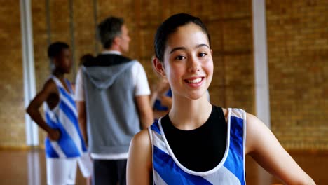 high school girl standing with basketball in the court 4k