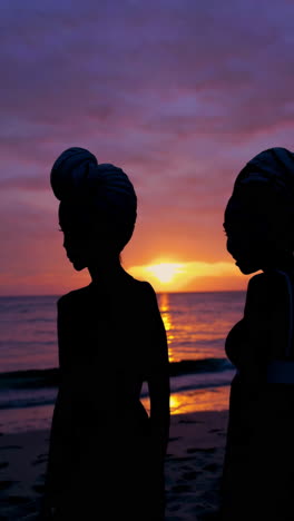 Silhouettes of Two Women on a Beach at Sunset