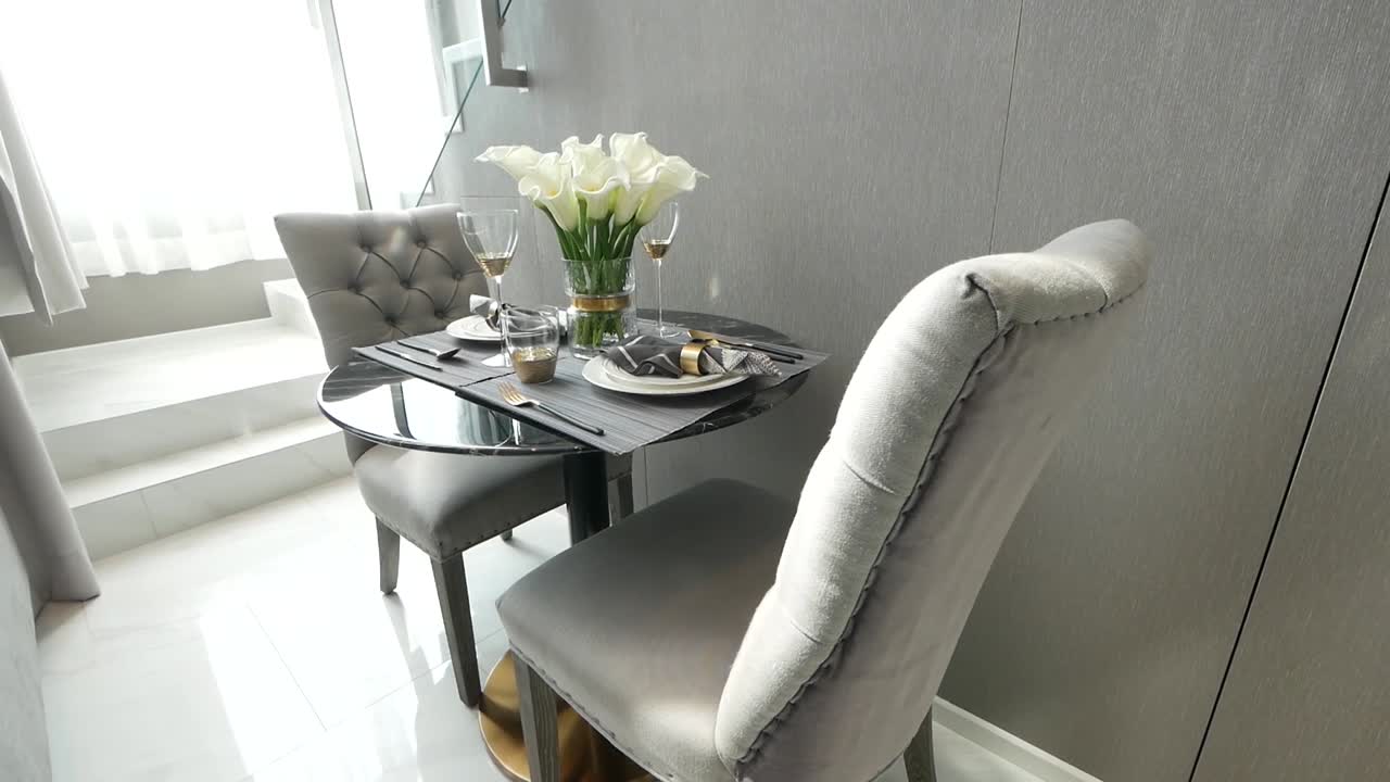 Decorated Rounded Glass Coffee table with Elegant Silver Chairs