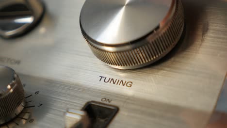 fm radio station tuning  on receiver by rotating tuner dial close-up 4k