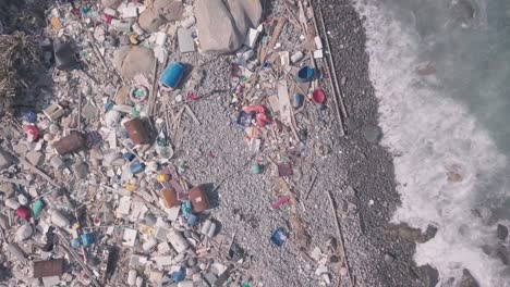 environmental issues shown by beach covered in plastic and rubbish in hong kong. static aerial drone view