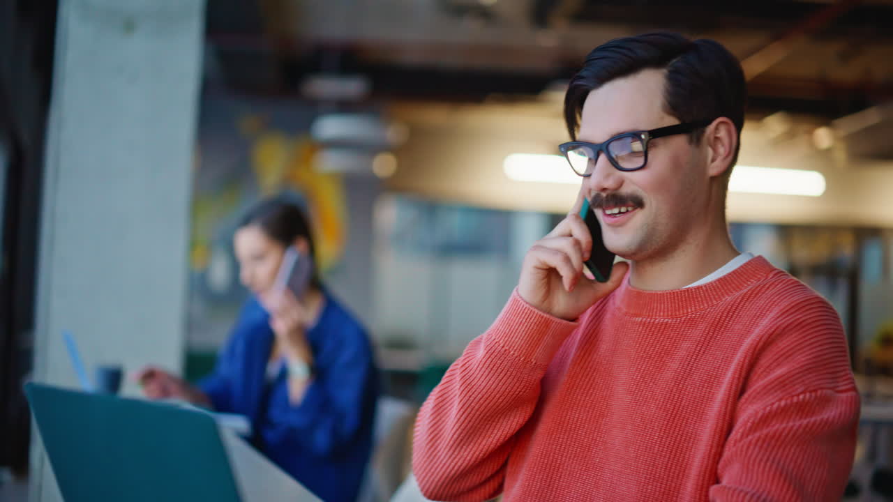 Sales managers calling cellphones in creative coworking closeup. Woman man