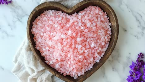 pink salt in heart-shaped bowl