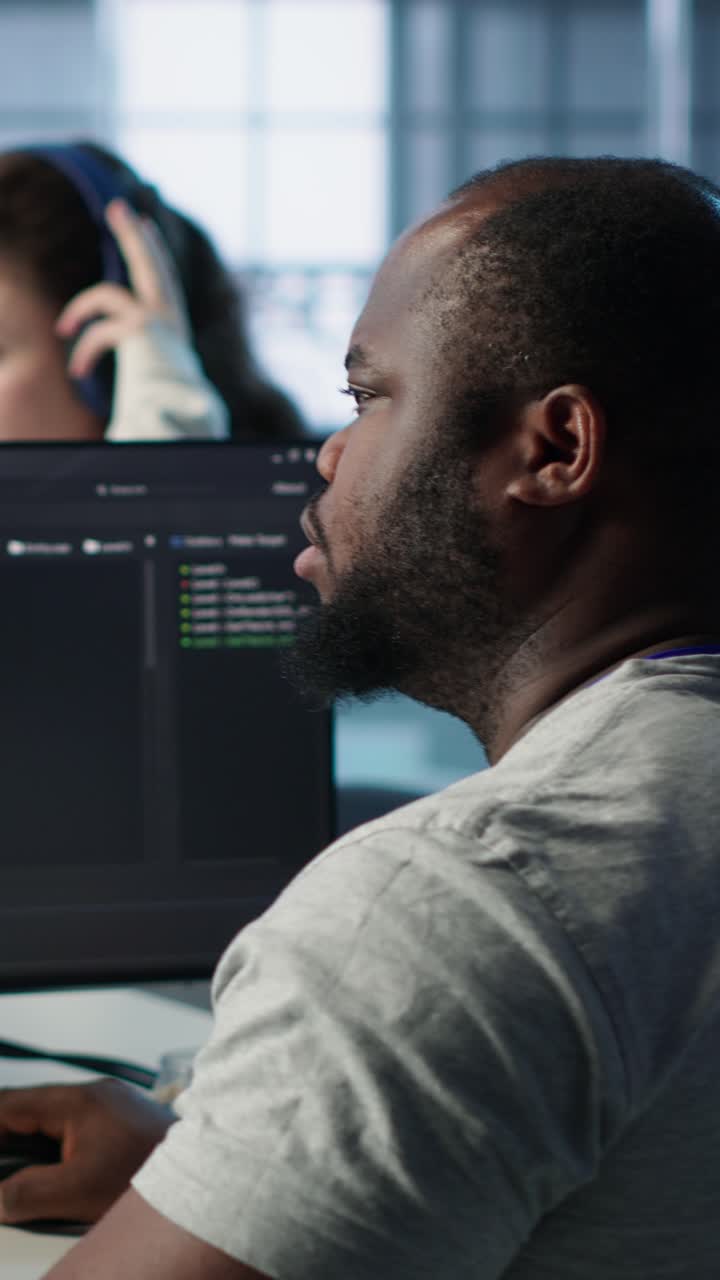 African American Man Coding on Computer in Modern Office