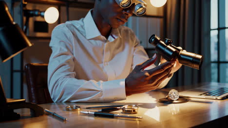 man examining a large diamond with a loupe