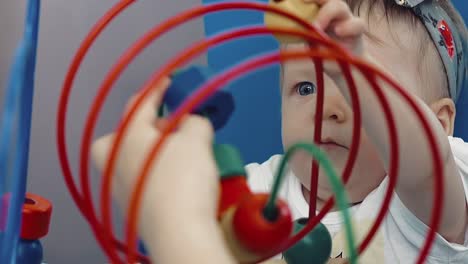 child plays with a multi-colored toy 22