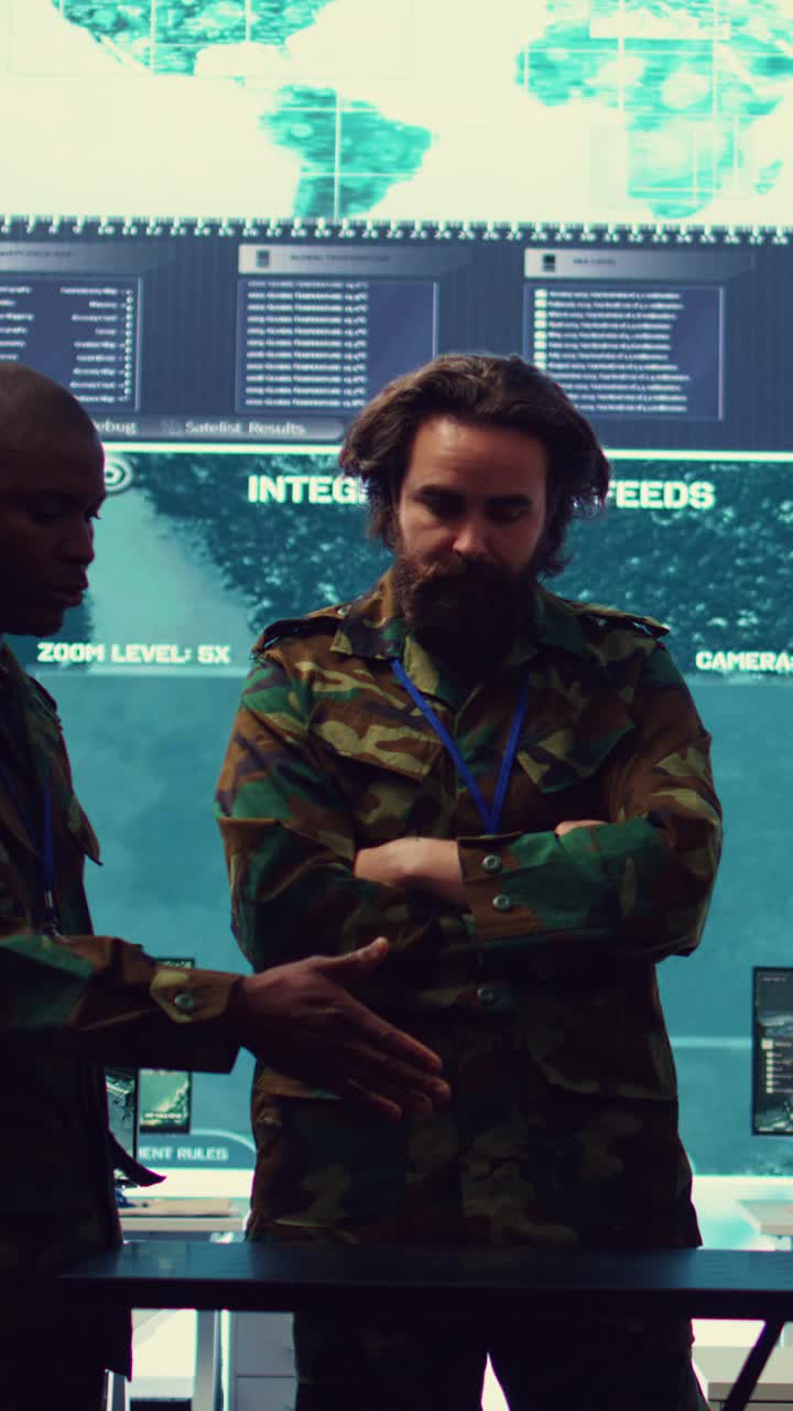 Military Officers Discussing Integrated Data Feeds in a Control Room