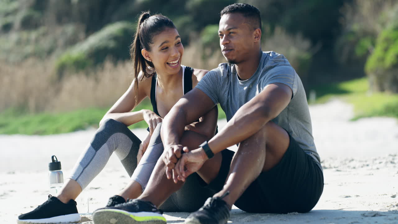 Couple Relaxing on Beach After Workout