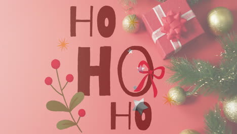 christmas decorations and gift box over ho text animation on pink background