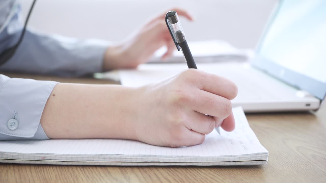 Close up image female hands typing on laptop keyboard