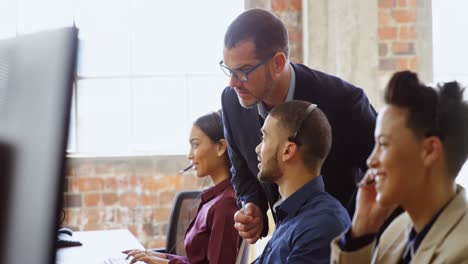 Executives-working-at-desk-in-office-4k