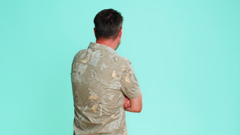 Adult man covering mouth with hand showing gesture of silence refusal to speak keeping secret quiet