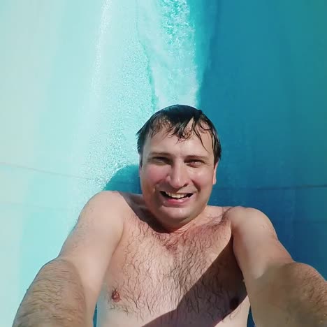 a man descends from a water slide with only feet visible 2