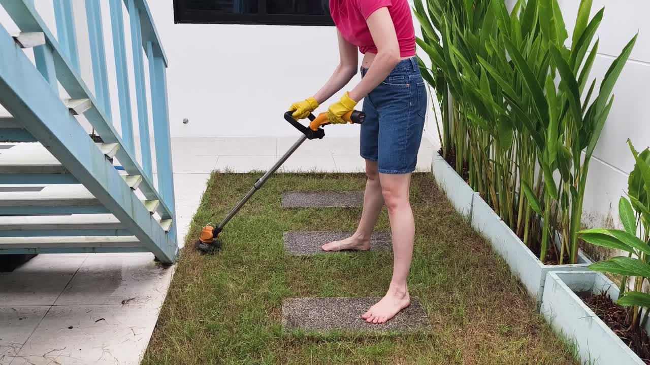 Woman Trimming Lawn Barefoot