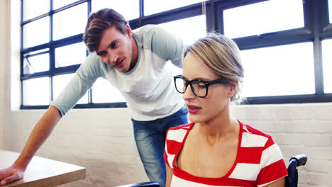 Colleagues-discussing-with-each-other-over-laptop