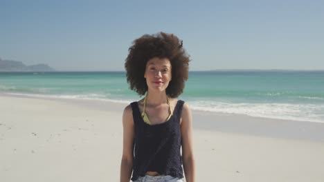 Mixed-race-woman-at-beach-looking-at-camera