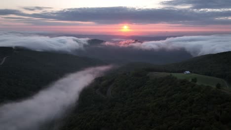 aerial-orbit-at-sunrise-with-fog-in-the-valley-between-boone-and-blowing-rock-nc,-north-carolina