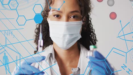 Animation-of-chemical-structures-over-biracial-female-doctor-with-vaccine-and-vial