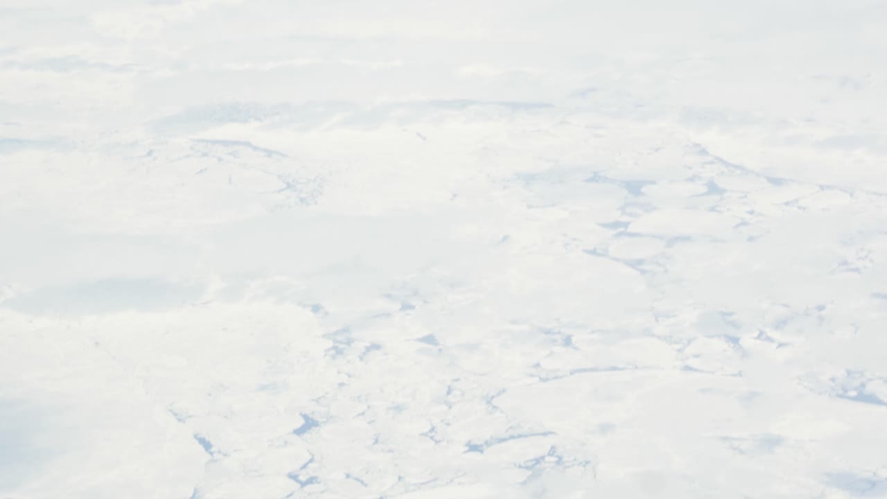 비행기에서 바다의 빙원 위의 조감도를 슬로우 모션으로 촬영 - 구름과 푸른 하늘까지 기울어짐