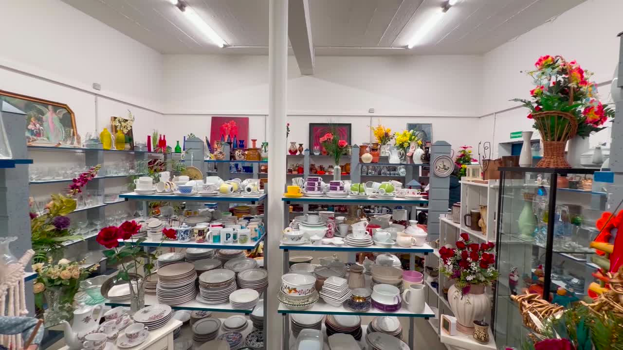 Glassware, plates, cups, and vases are available for selection in fully stocked display cases, panning shot