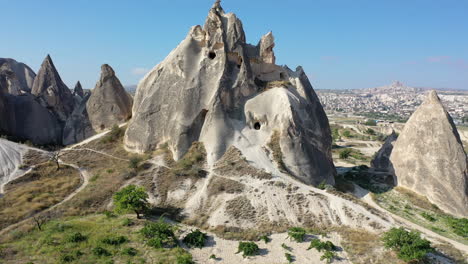 revealing cinematic epic drone shot of a large rock standing up over cappadocia, turkey