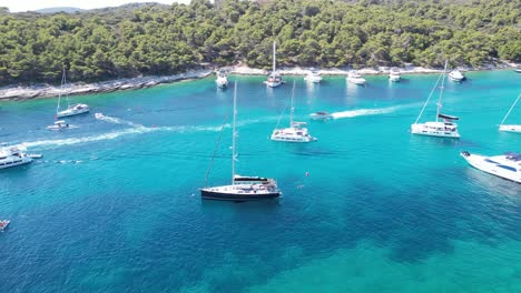 boats anchored in the calm waters around the paklinski islands, croatia, with scenic views of lush islands and azure waters