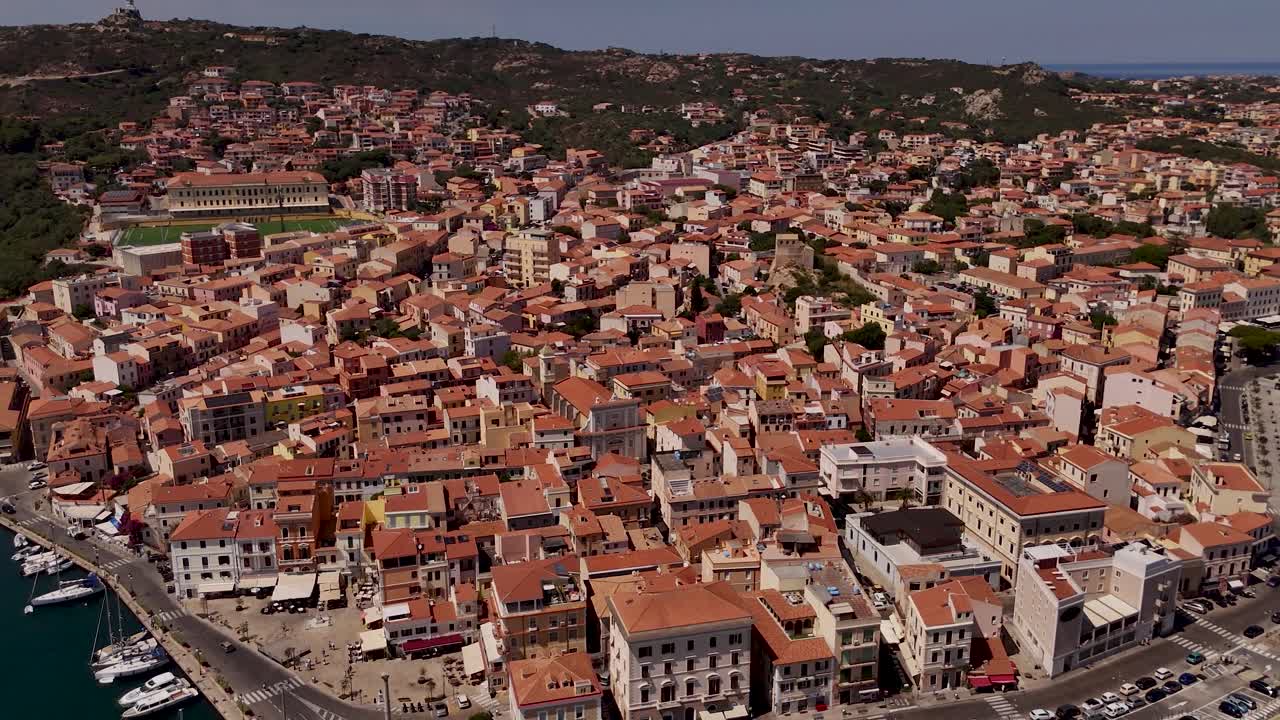 Aerial view of Sardinia's La Maddalena with vibrant rooftops and blue skies