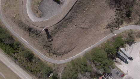 Top-Down-Aerial-Drone-Footage-Dollying-forward-over-a-Creepy-Abandoned-Hotel-with-a-Covered-Pool