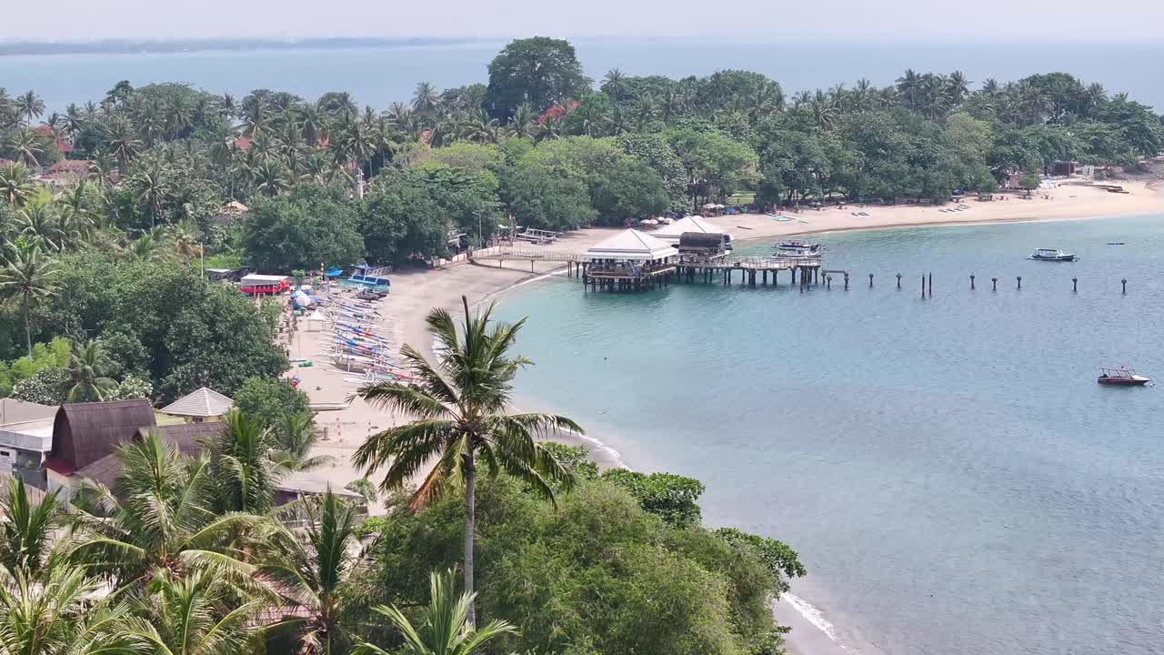 Amazing aerial of Senggigi Beach over palm tree. Tropical coastal of Lombok, Indonesia.