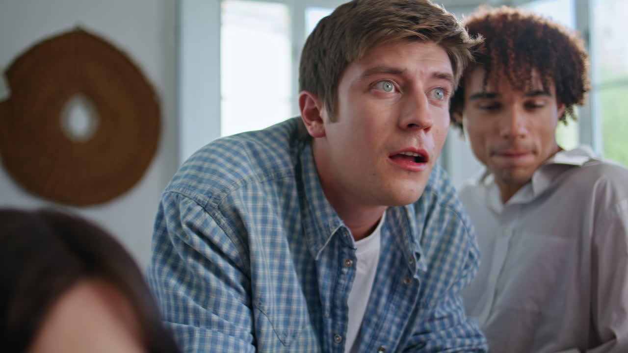 Emotional men playing playstation game home closeup. People enjoying video games