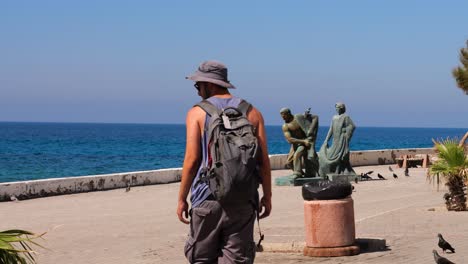 Male-Tourist-With-Backpack-Walking-Along-Promenade-In-Nicosia