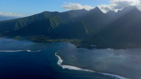 moorning sun shadows layers clouds teahupoo tahiti  aerial drone french polynesia south pacific towering mountains peaks coast sunrise surf wave reef channel wsl surfing olympic venue backwards