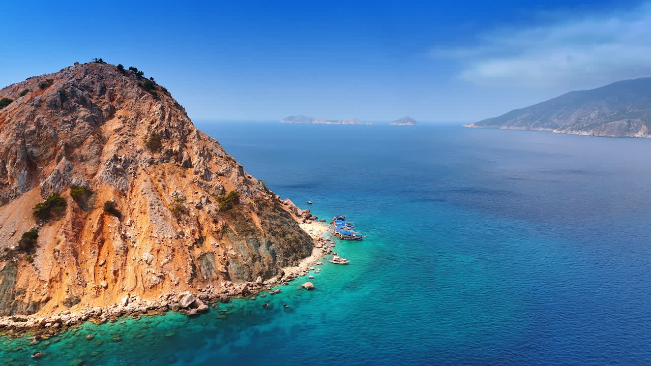 Approaching the bare rock surrounded by azure waterscape. Suluada island, Turkey in the Mediterranean Sea