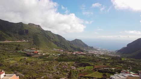 Local-Tenerife-town-with-view-to-ocean,-aerial-ascend-view