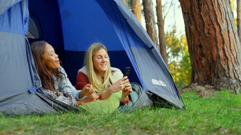 women discussing on mobile phone in camping tent 4k