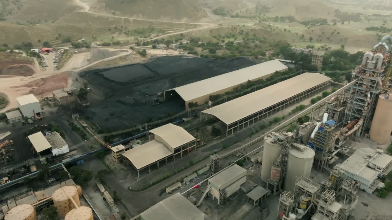 Aerial view of a cement factory in Karachi, Pakistan, highlighting coal storage and industrial operations