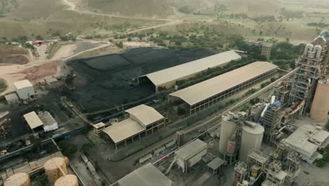 aerial view of a cement factory in karachi, pakistan, highlighting coal storage and industrial operations