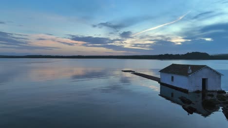 Cinematic-drone-footage-along-the-water-with-reflections-of-clouds